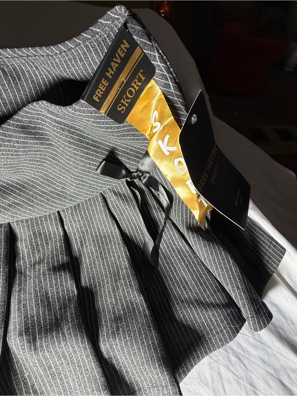 Free Haven Women's Pinstripe Pleated Mini Skort with black bow accents- Black- L - Picture 5 of 7